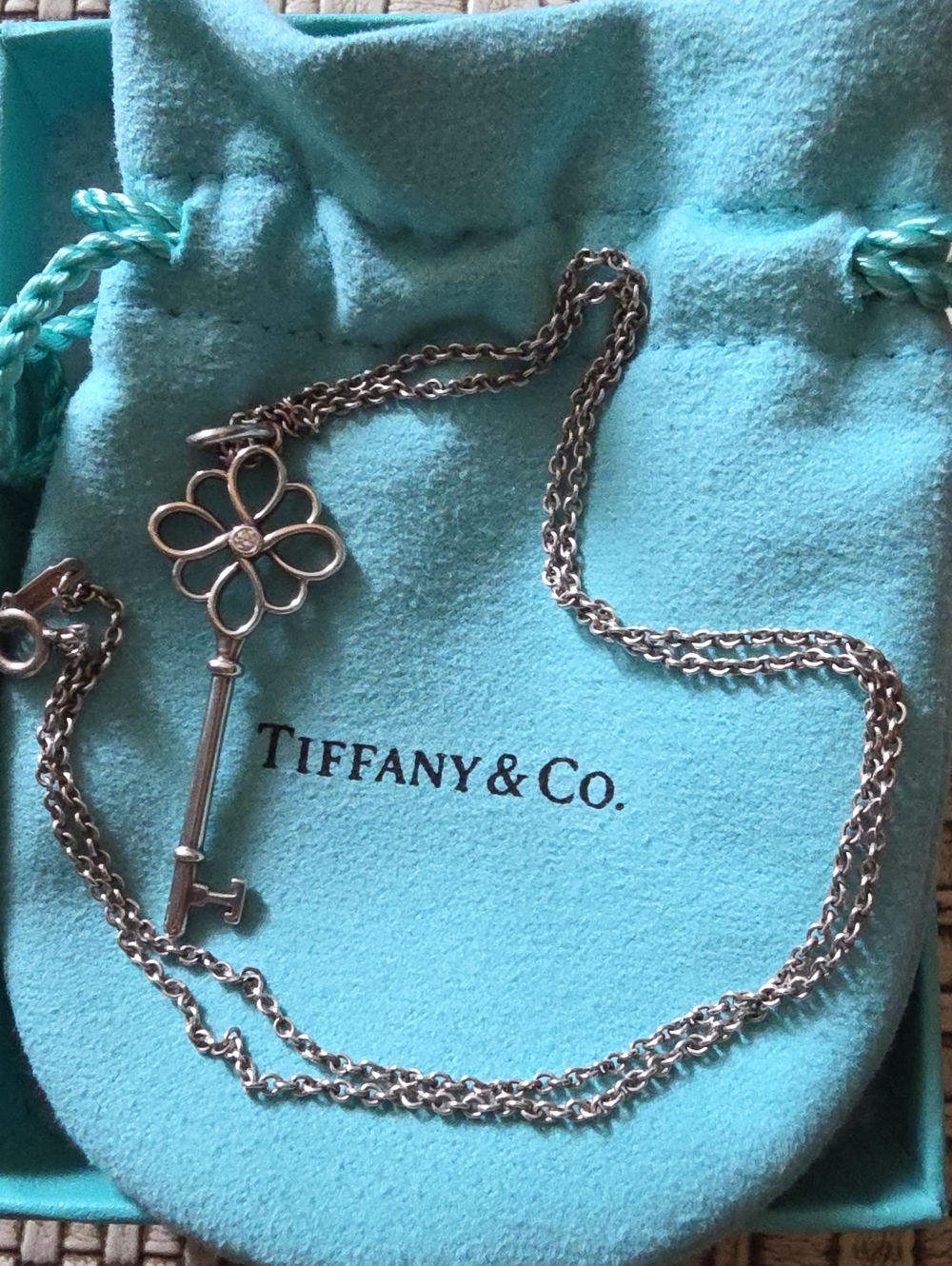 Tiffany & Co. Silver Key Pendant Necklace with Flower Motif